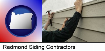 installing vinyl siding on a house in Redmond, OR