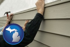 michigan map icon and installing vinyl siding on a house