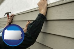pennsylvania map icon and installing vinyl siding on a house