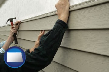 installing vinyl siding on a house - with North Dakota icon