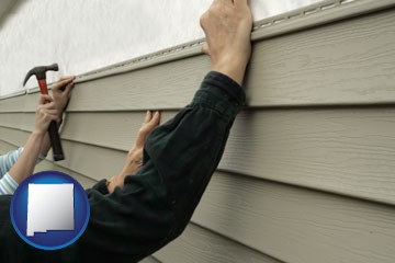 installing vinyl siding on a house - with New Mexico icon