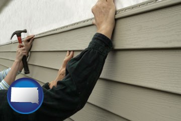 installing vinyl siding on a house - with South Dakota icon