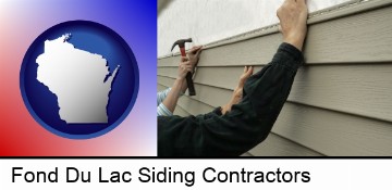 installing vinyl siding on a house in Fond Du Lac, WI